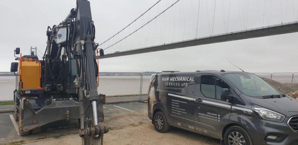 Humber Bridge as a backdrop for this Xwatch XW2 rated capacity indicator c/ w height limit on a Volvo EWR150e with TAB boom.